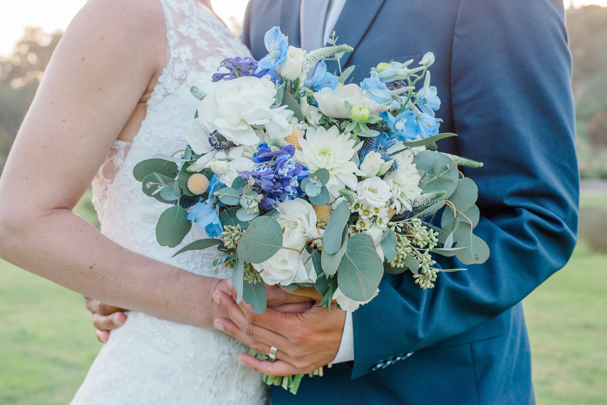 bride and groom together after wedding holding bouquet
