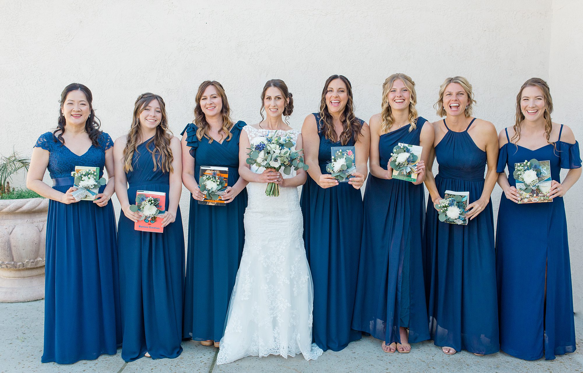bride with bridesmaids holding book gift