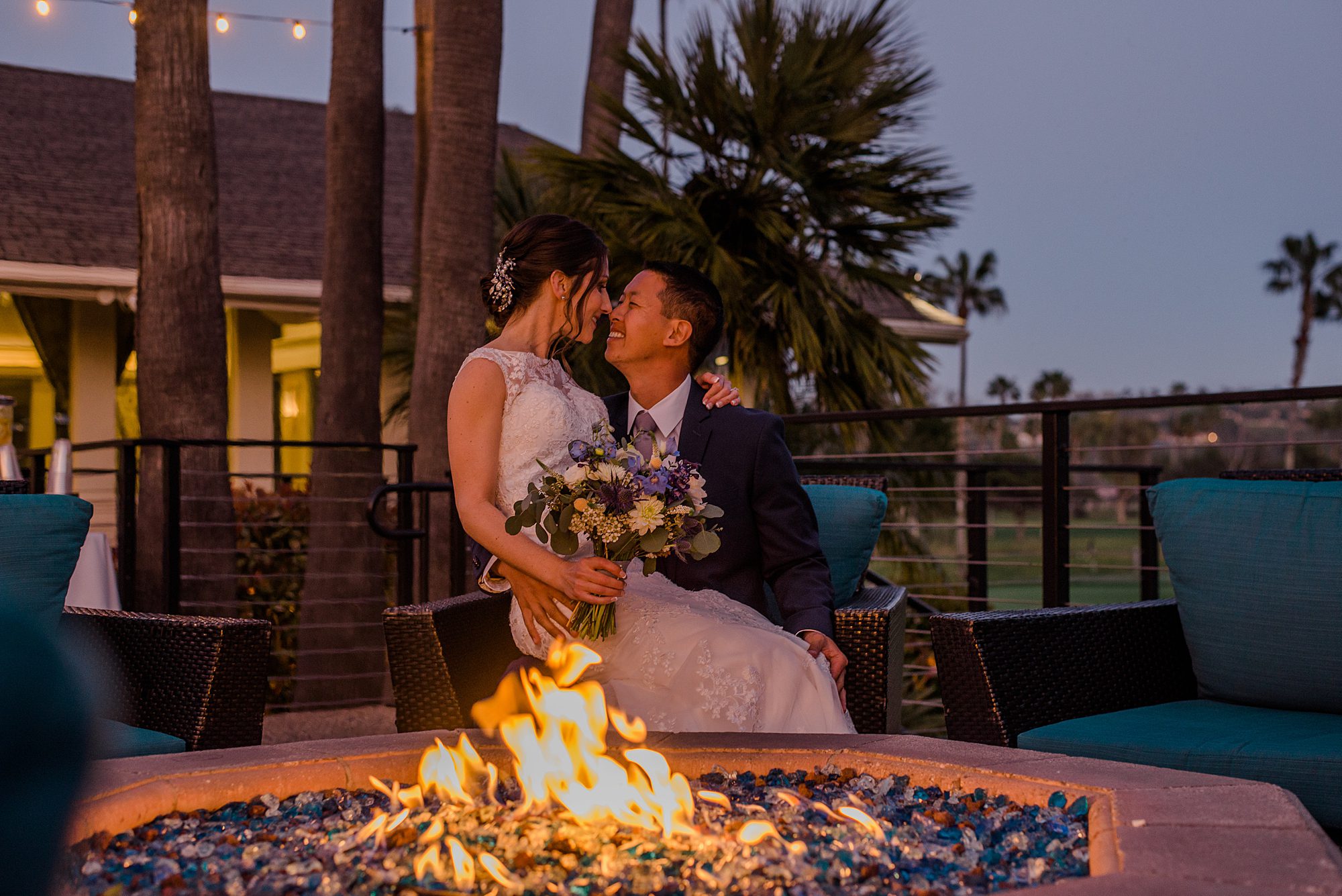 couple share intimate moment by the fire at Morgan Run Club & Resort