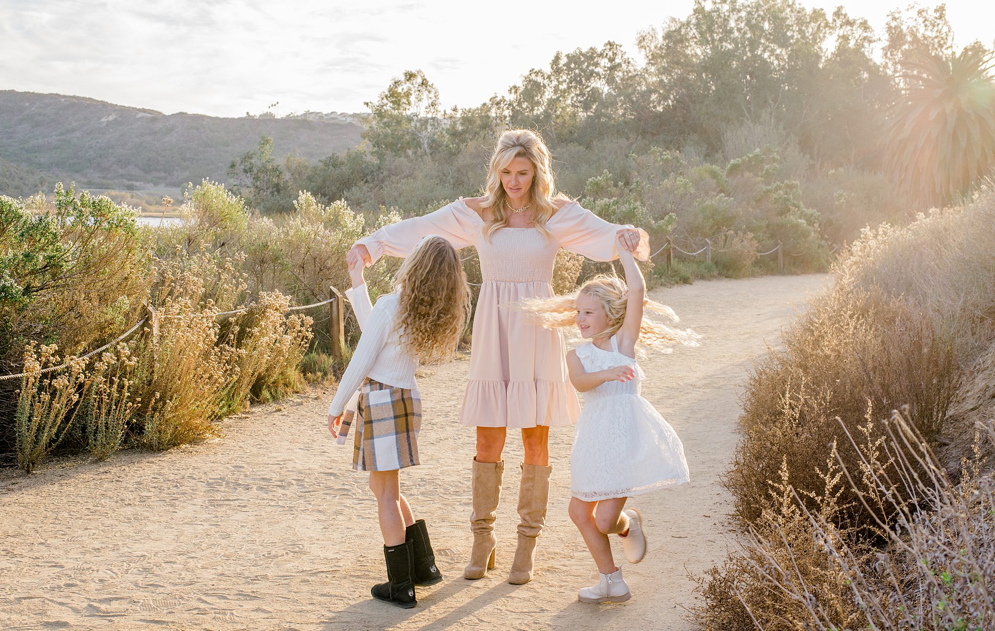 mom twirls her two daughters 