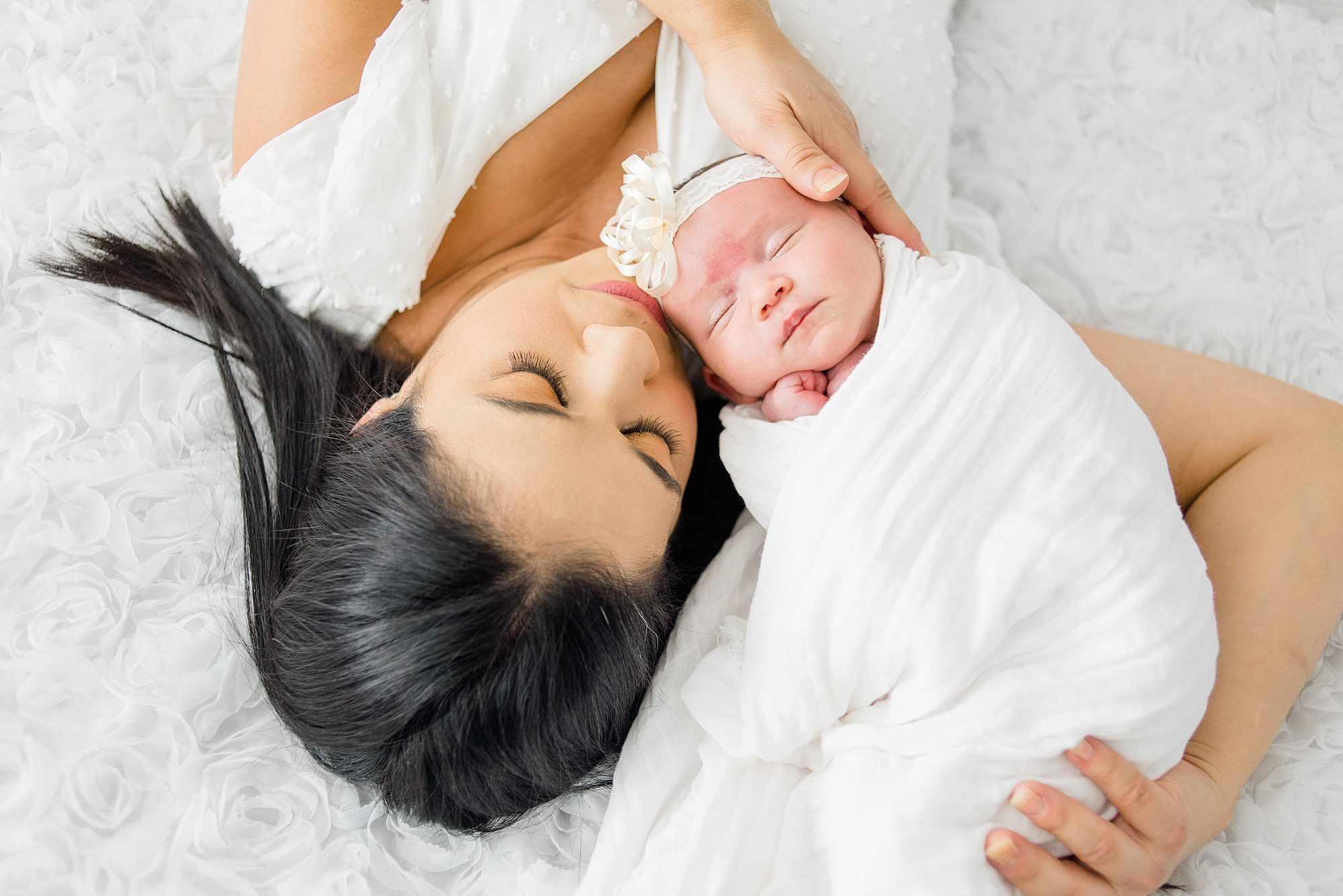 classic portraits of mom and newborn laying together