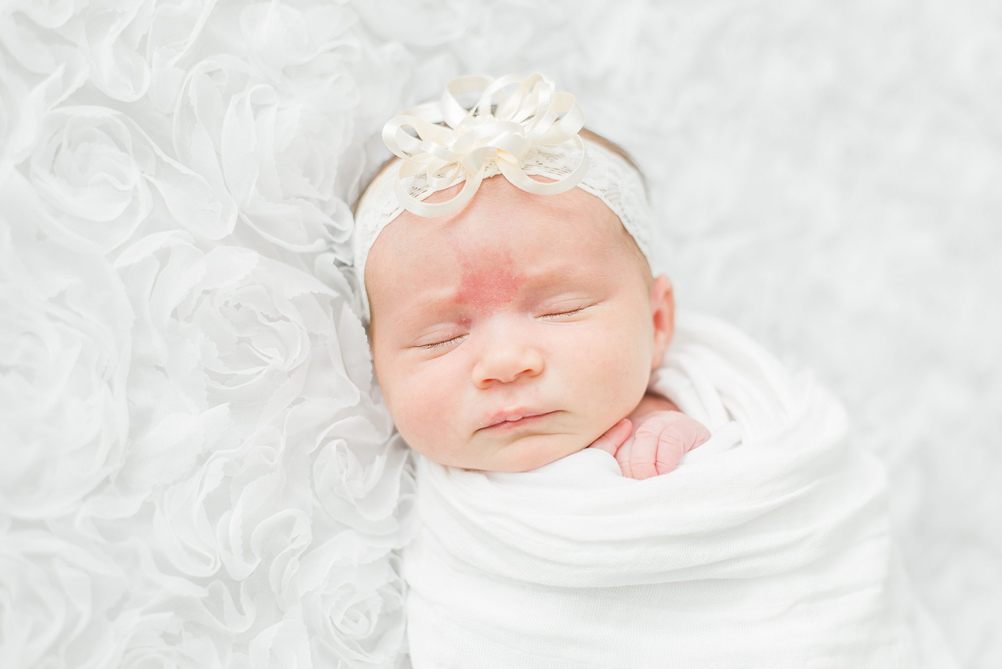newborn girl sleeps during in-home session