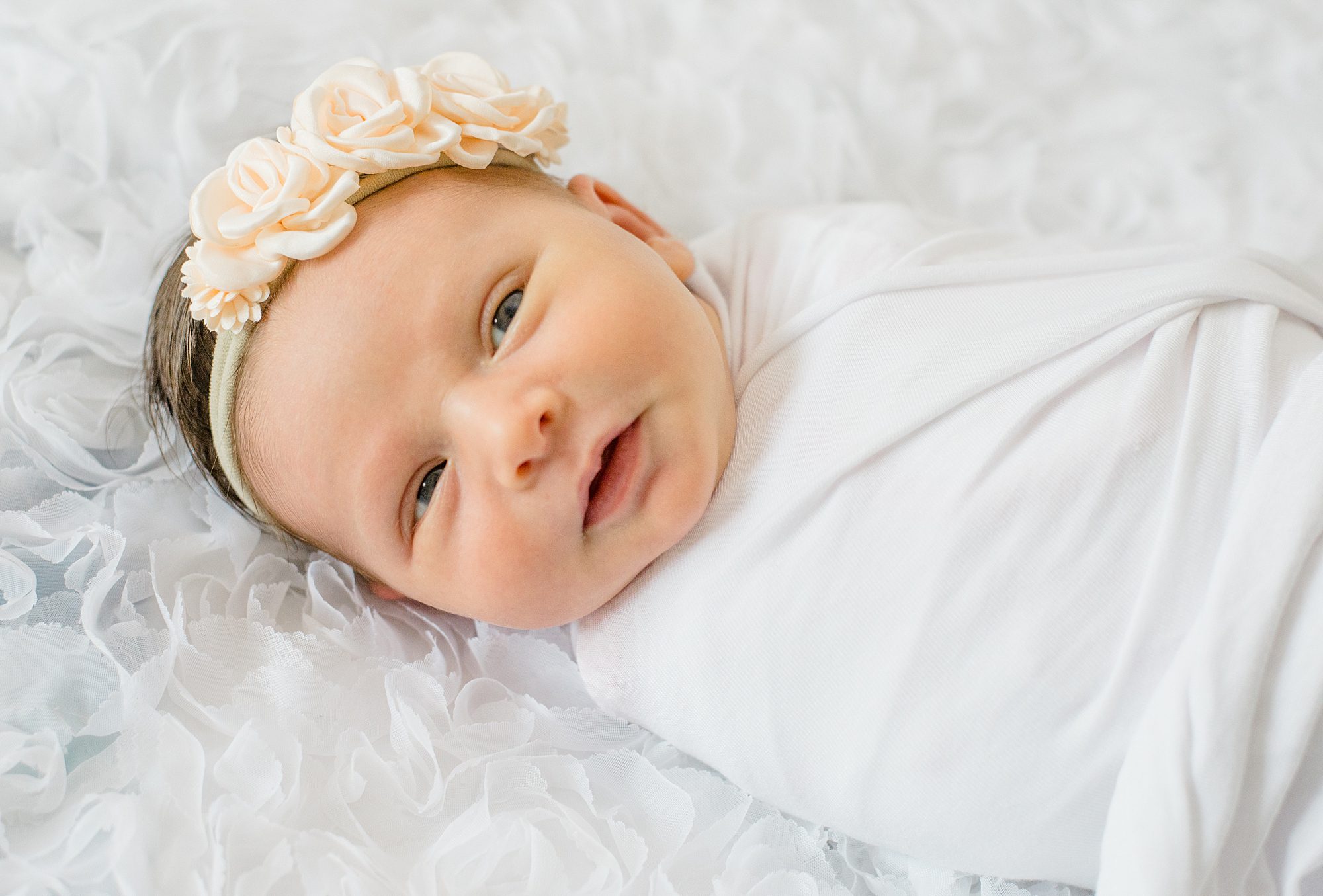 Timeless Newborn Portraits of baby girl wrapped in white 