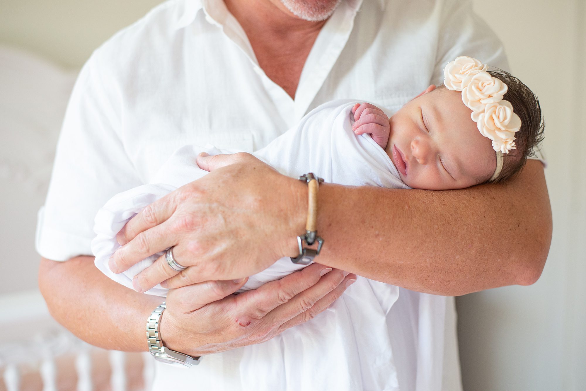 Timeless Newborn Portraits of baby girl in dad's arms