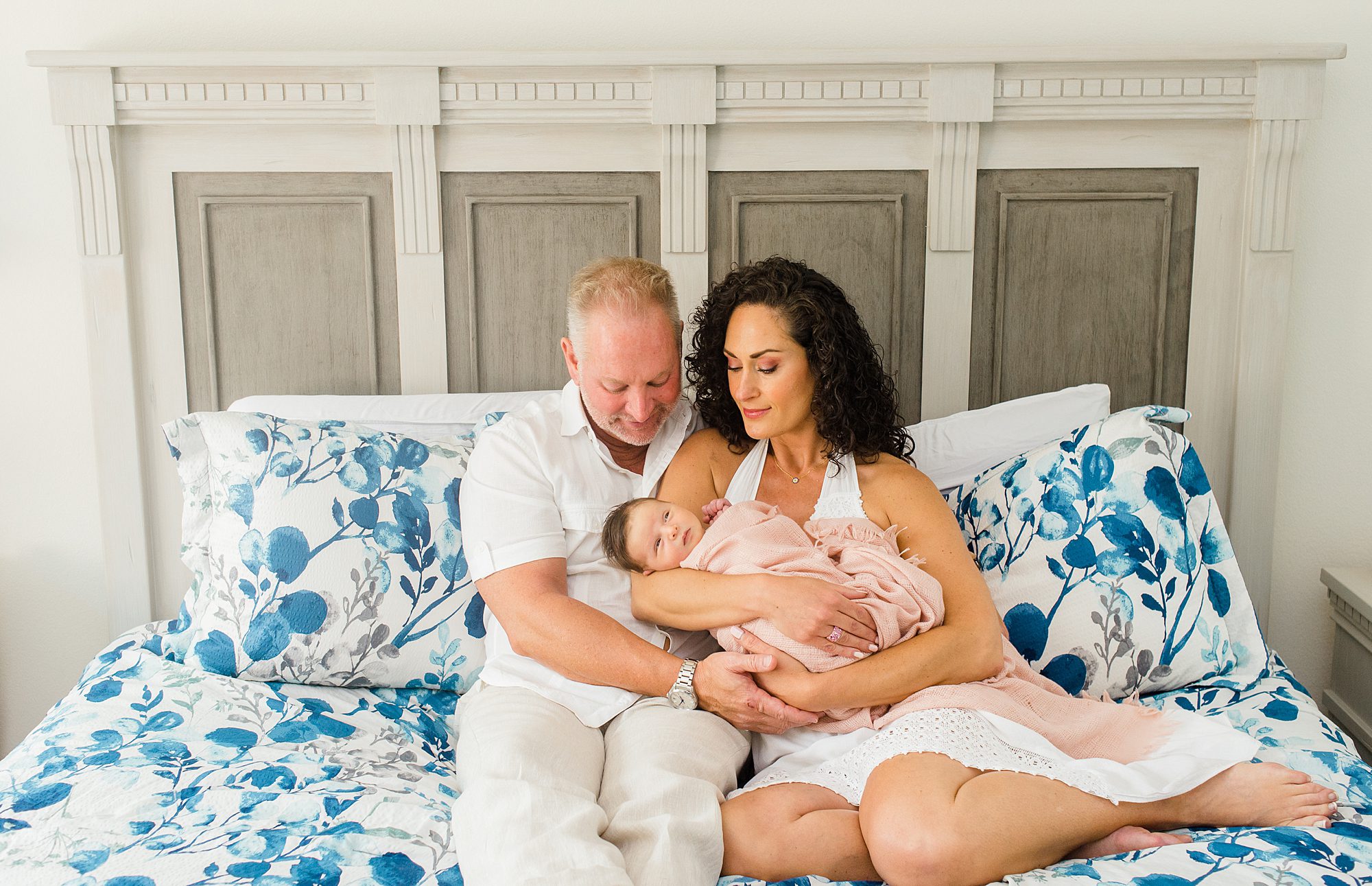 Timeless Newborn Portraits of new parents holding baby girl