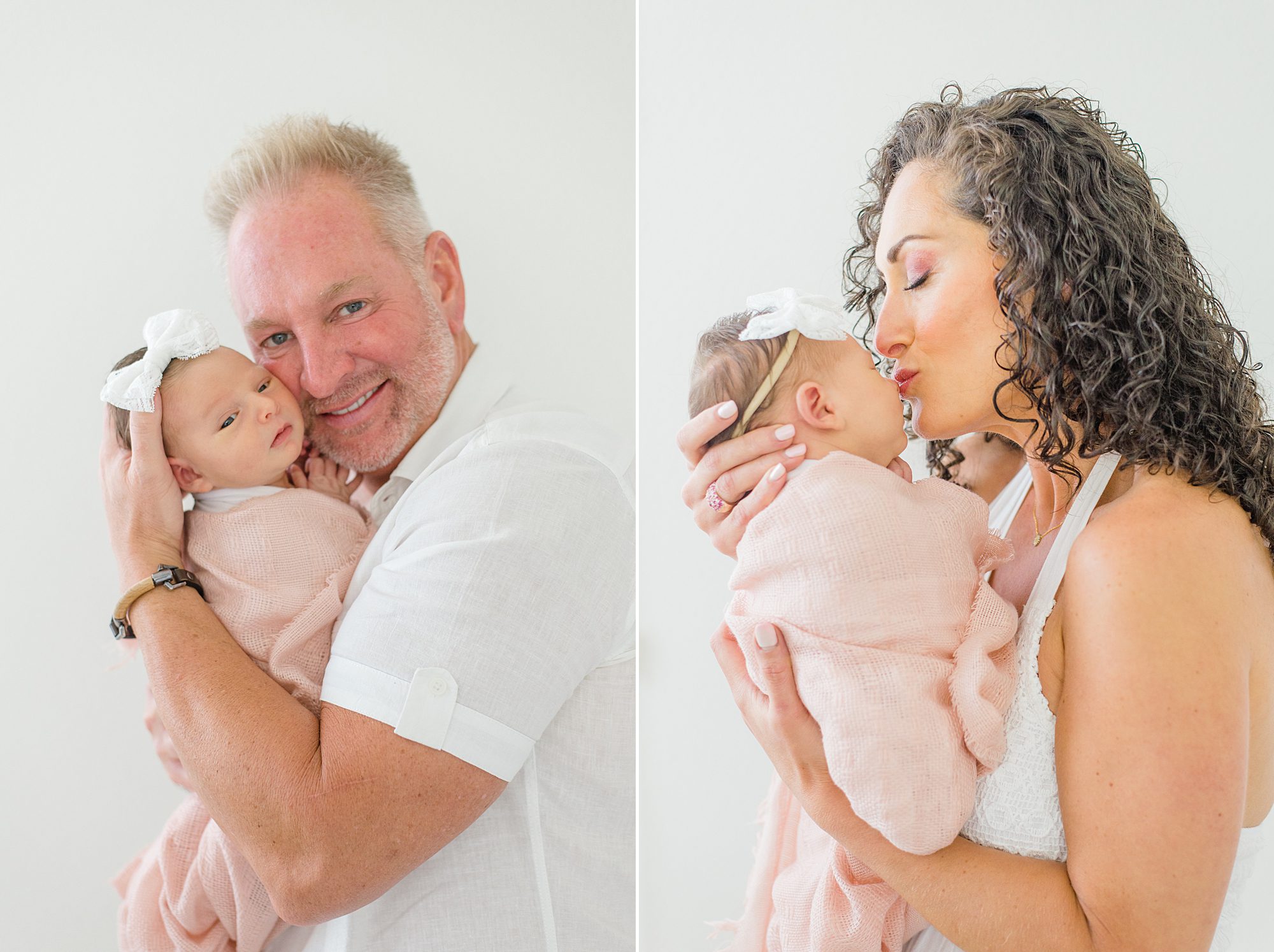 parents hold their newborn daughter in their arms
