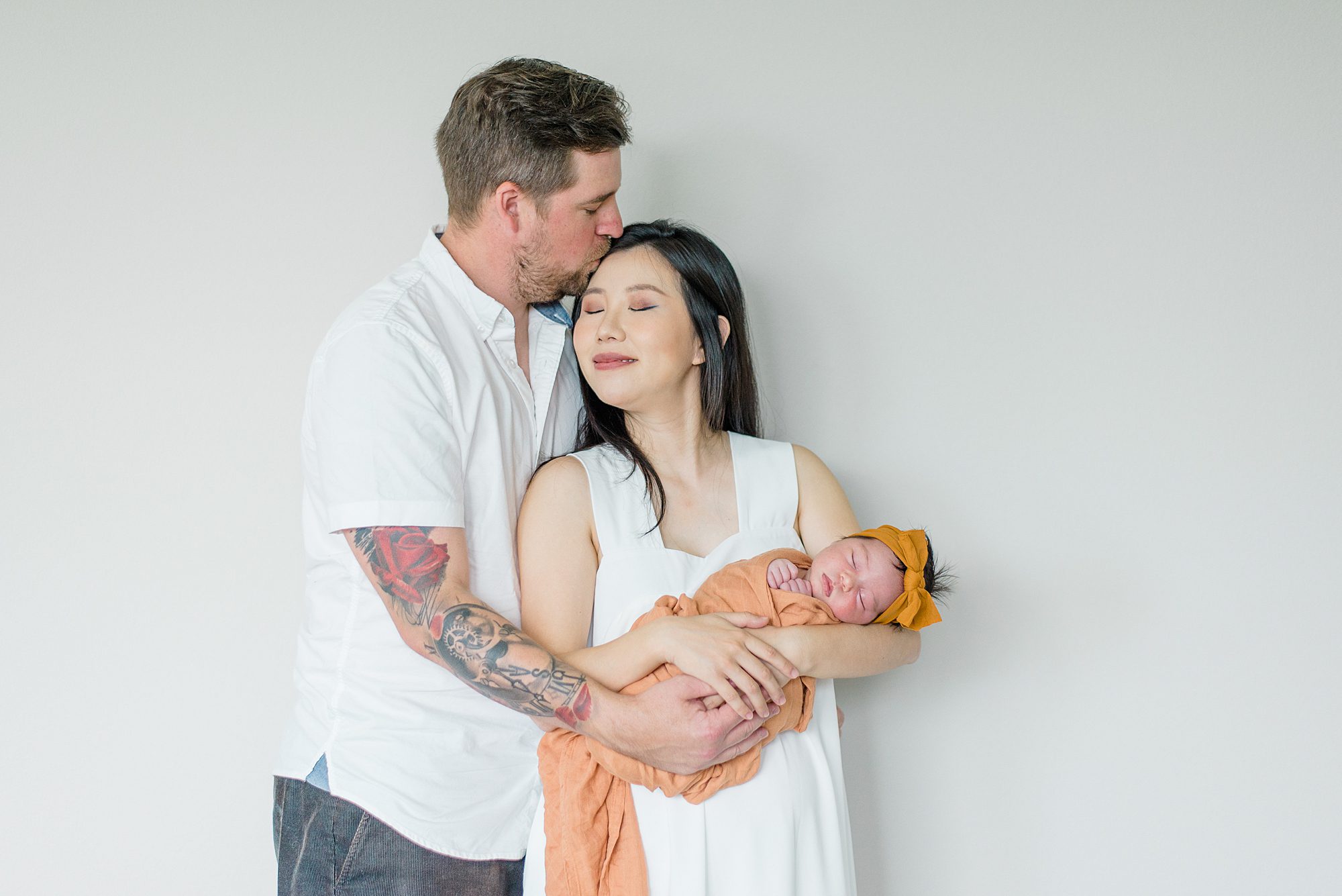 candid portaits of parents holding newborn girl