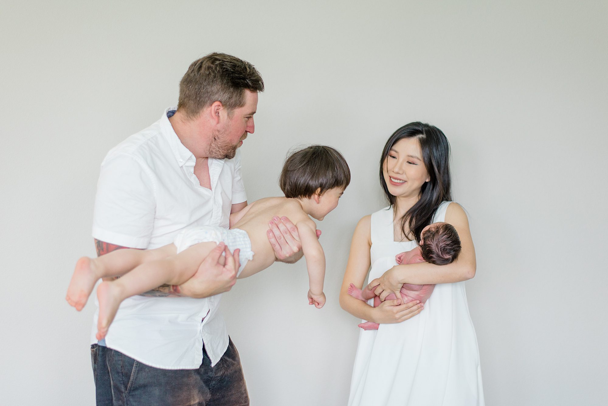 sweet candid portaits of family four during Harmony Grove In-Home Newborn Session 