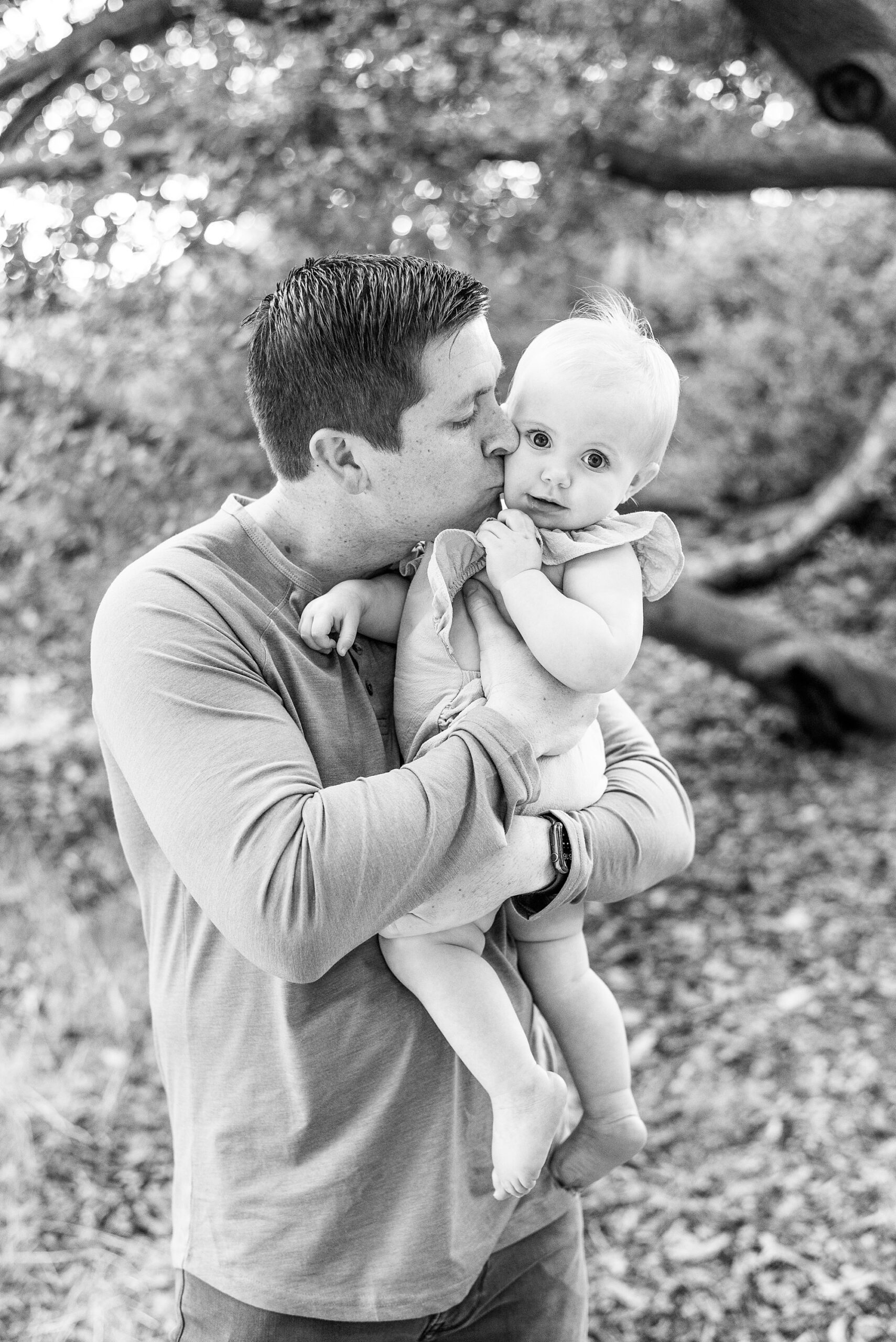 dad kisses his daughter's cheek