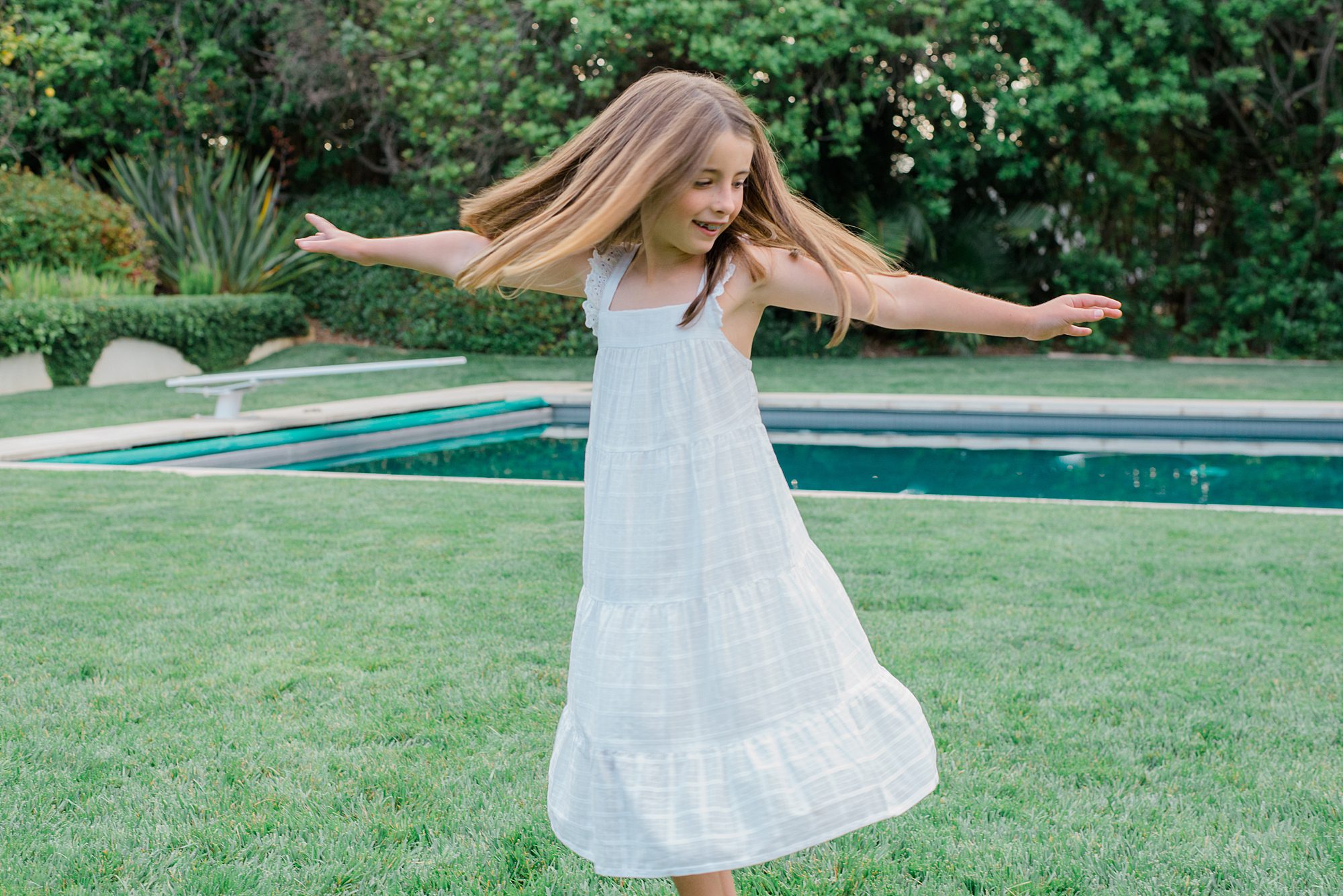 little girl dances in the yard