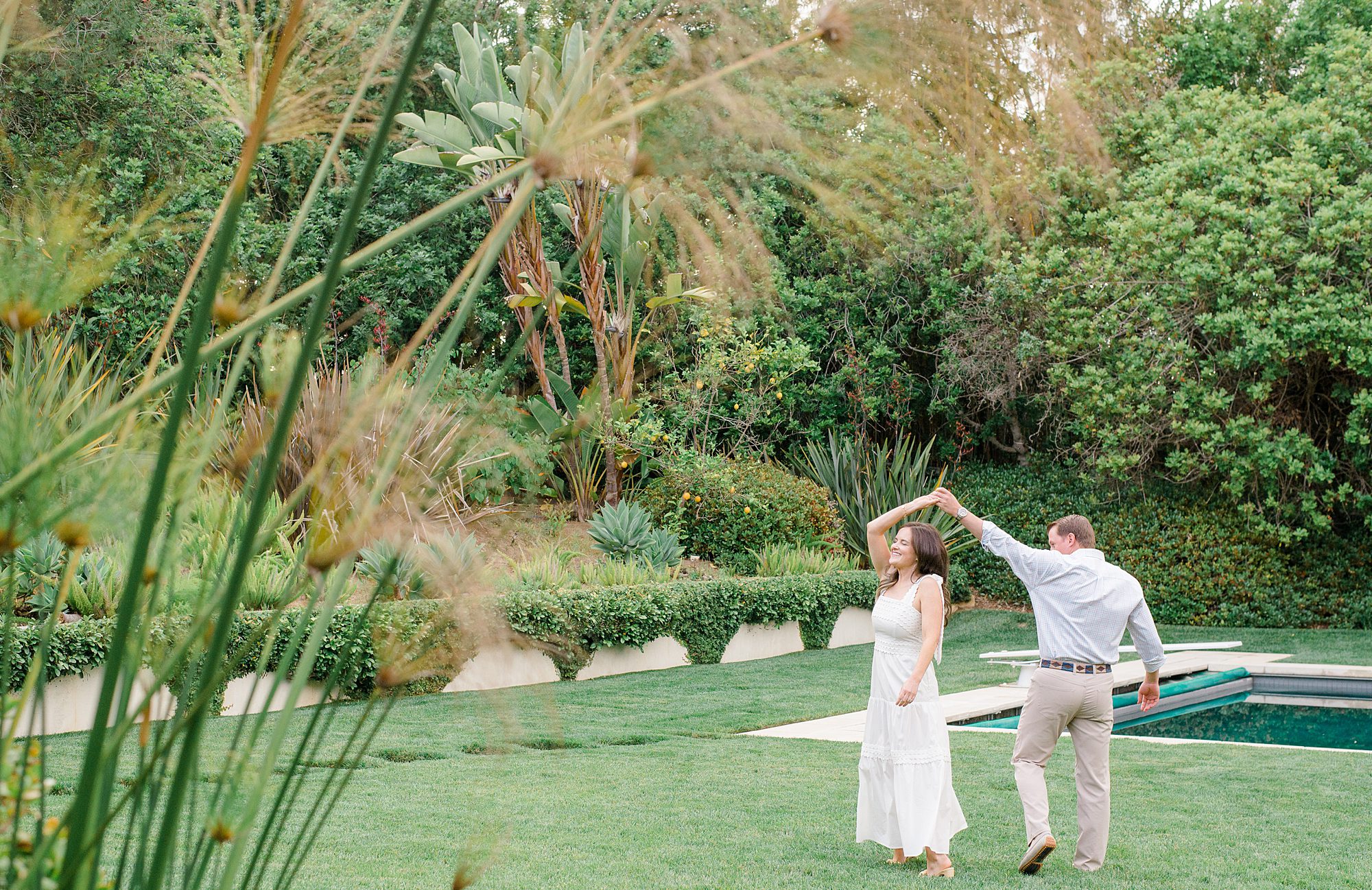 husband twirls his wife around during couple portraits