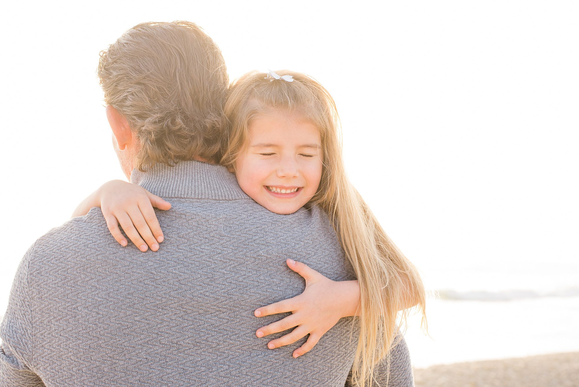little girl hugs her dad