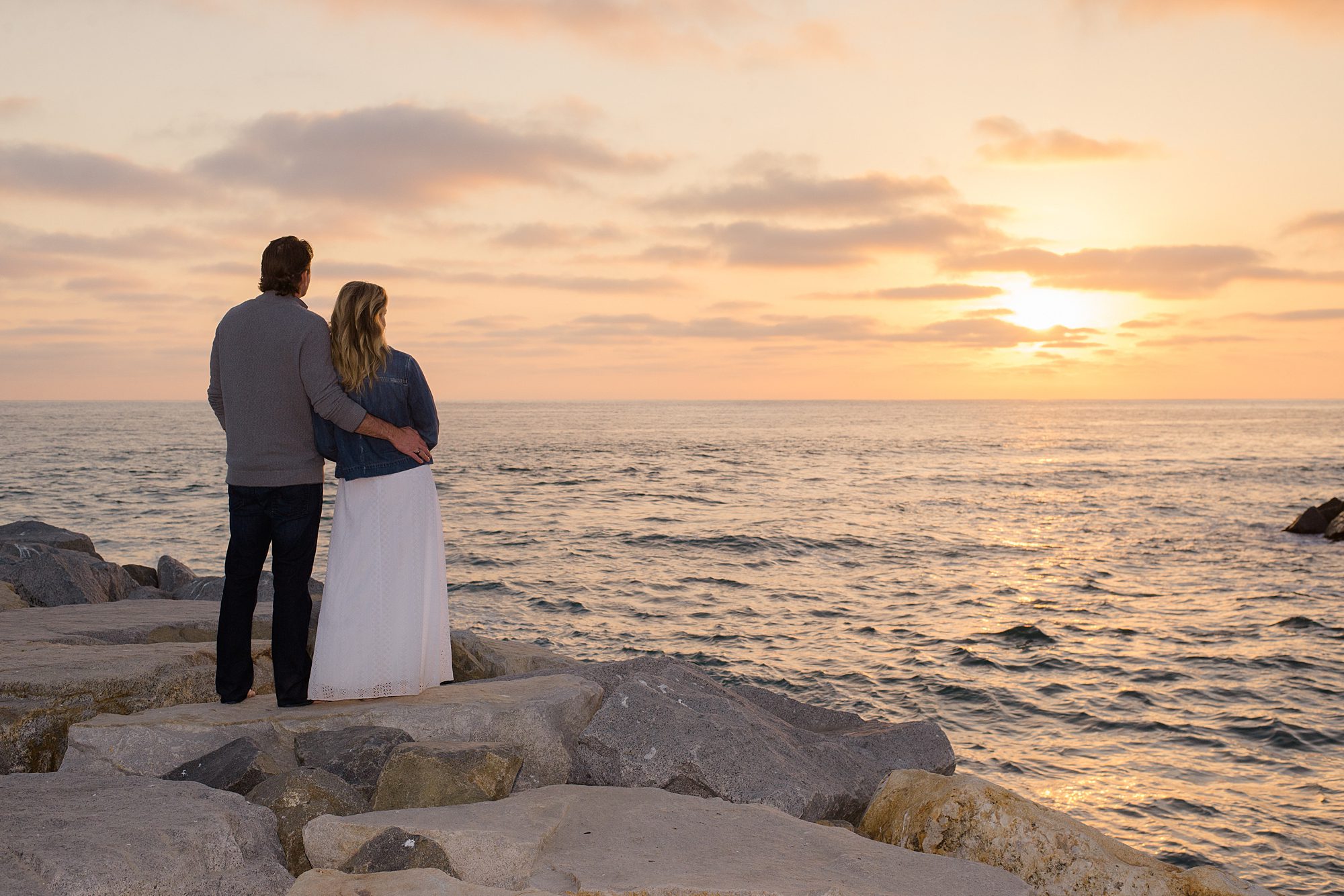 couple watch the sunset in Carlsbad CA