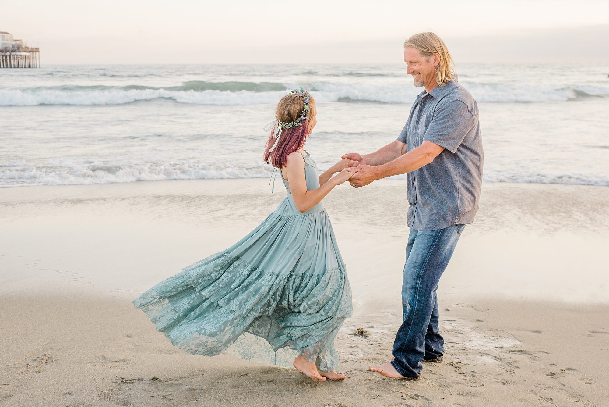 dad dances with his daughter on beach during Oceanside California Family Session