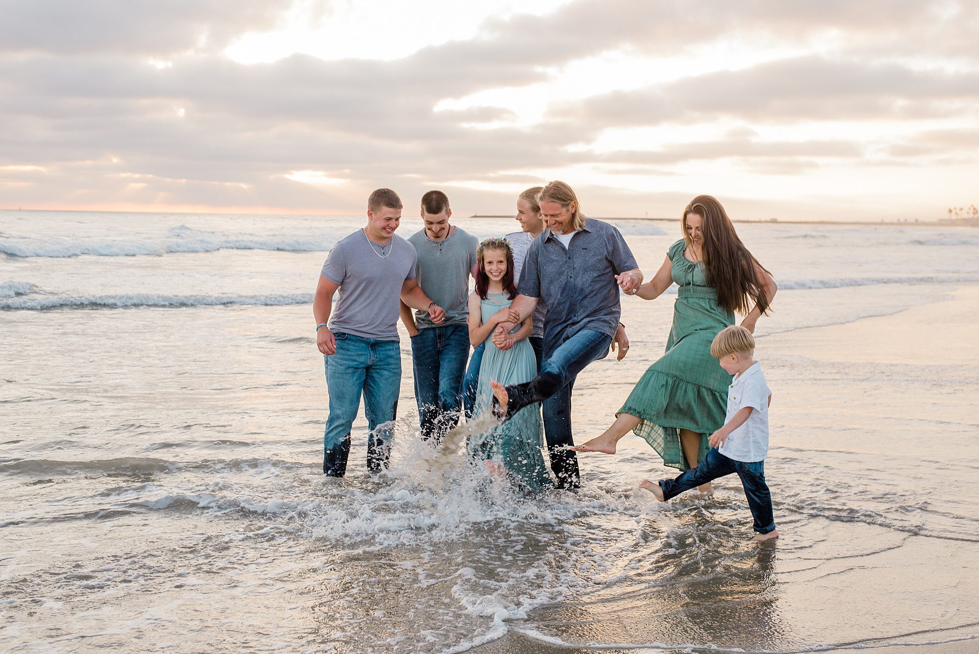 family splashes in the ocean