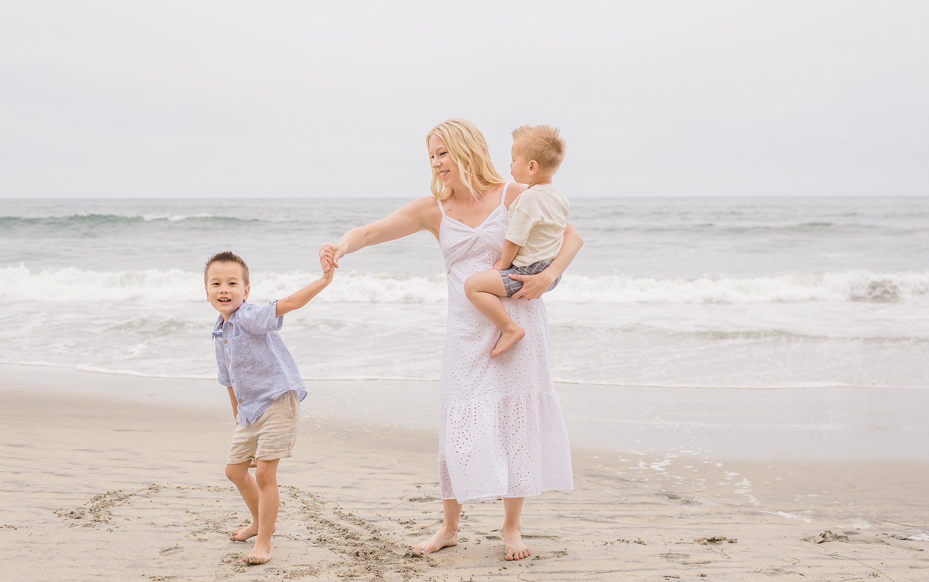 mom walks with her two boys from San Diego Family Beach Session