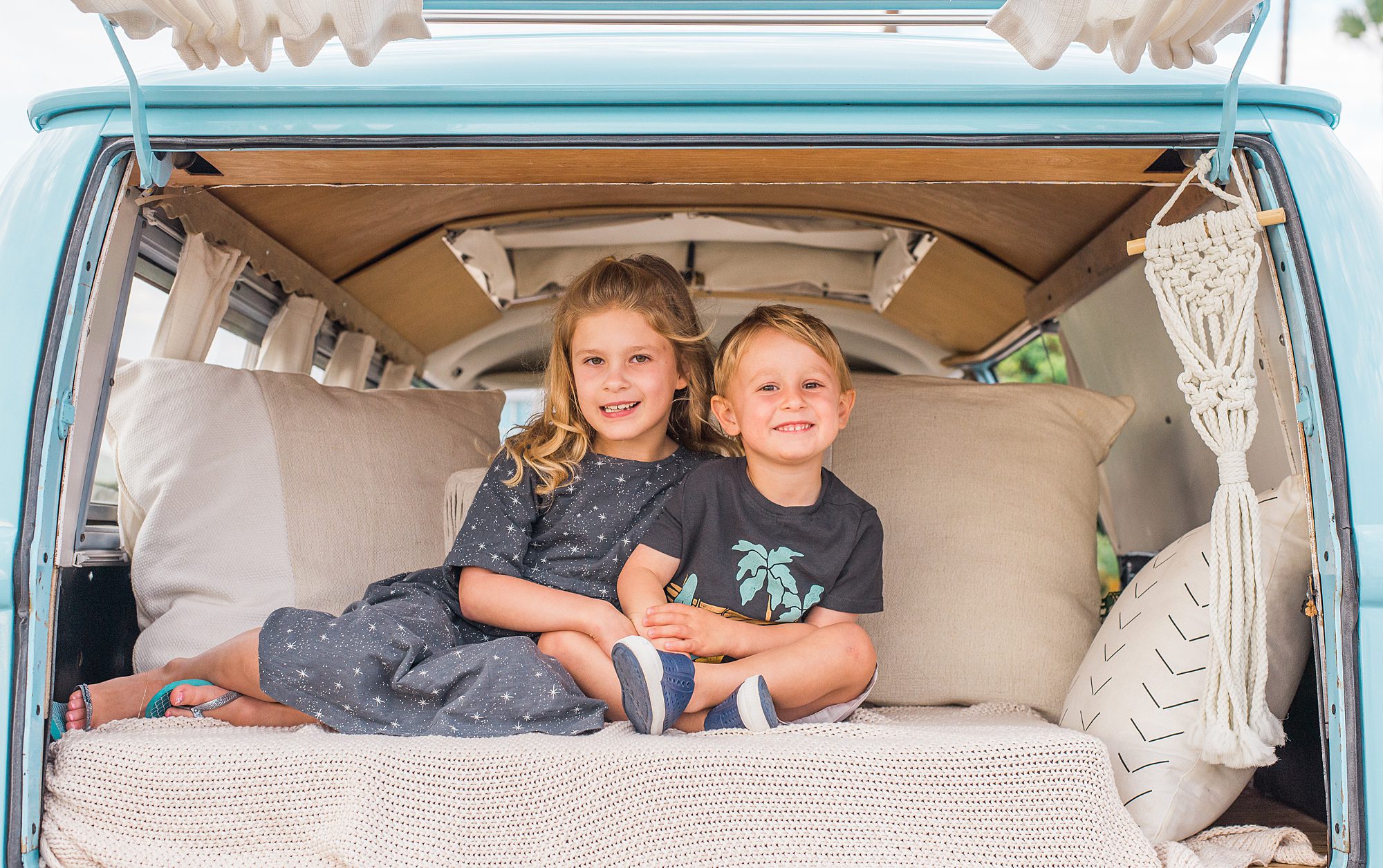 brother and sister sit together in the funky bus during family session