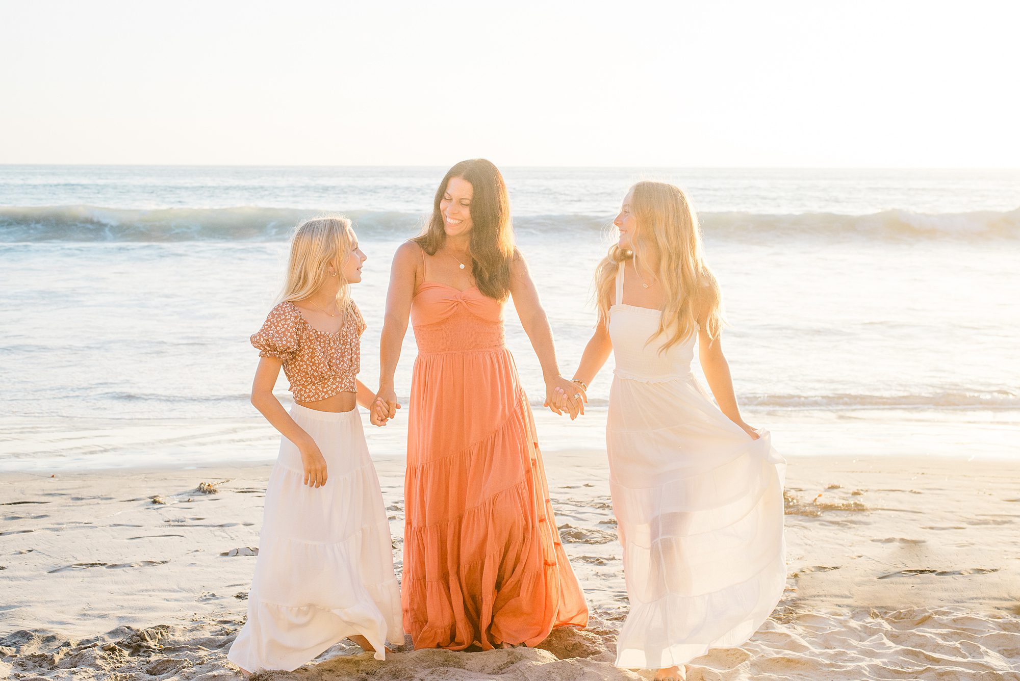 mom walks with her two daughters at Solana Beach 