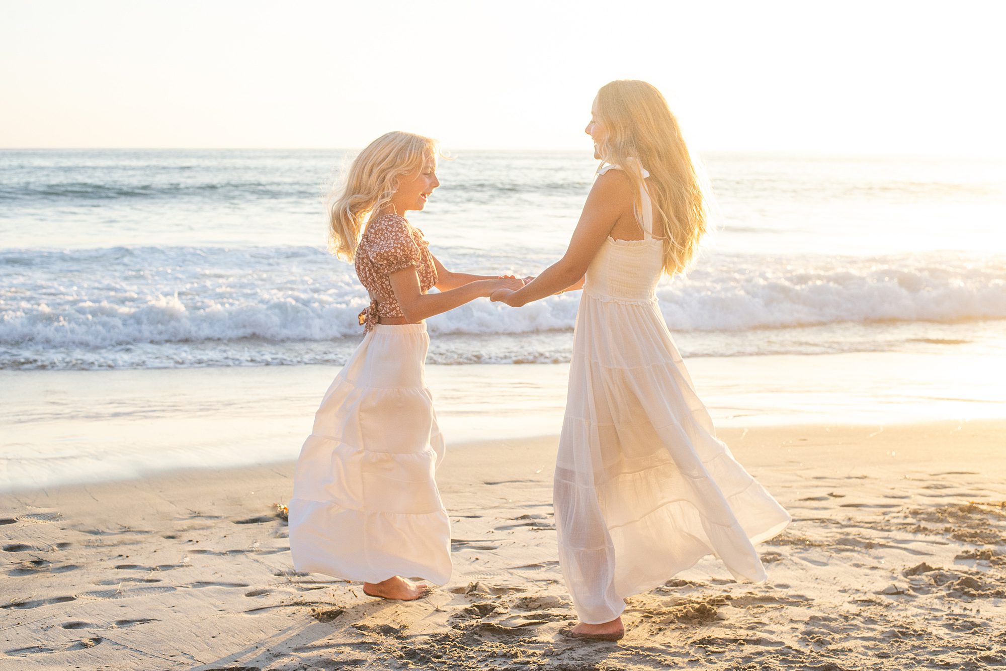 sisters dance on the beach in CA