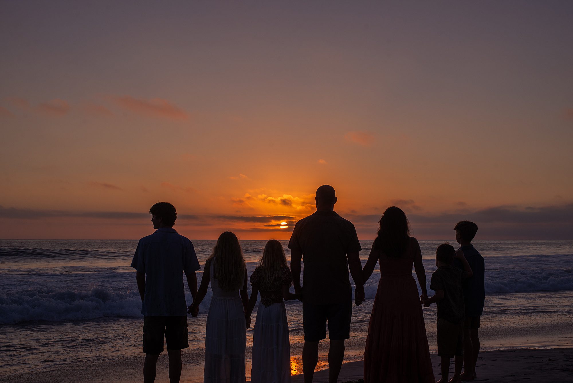 epic family portrait of family at sunset on Solana Beach in California 
