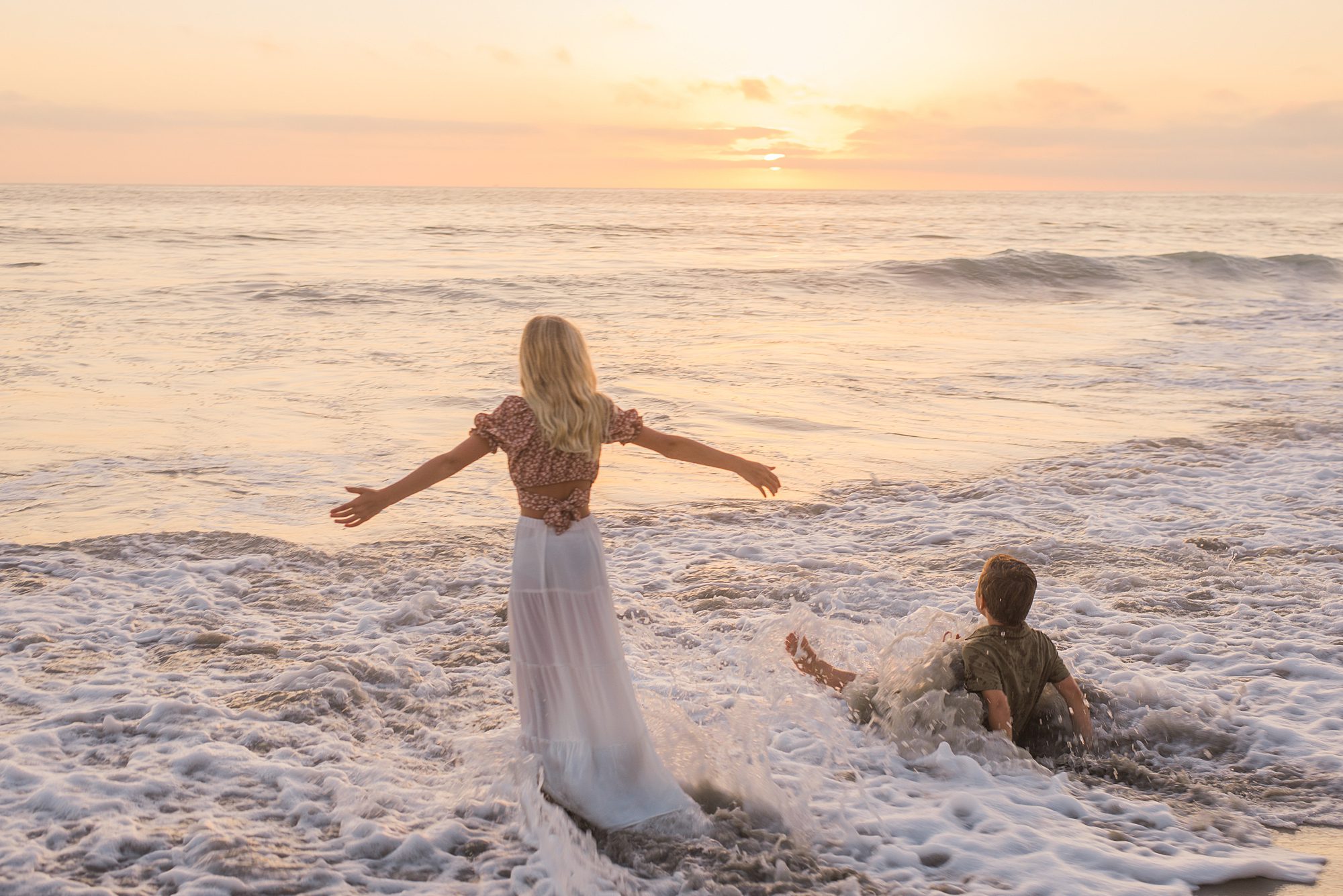 children in ocean at sunset during Solana Beach Family Session