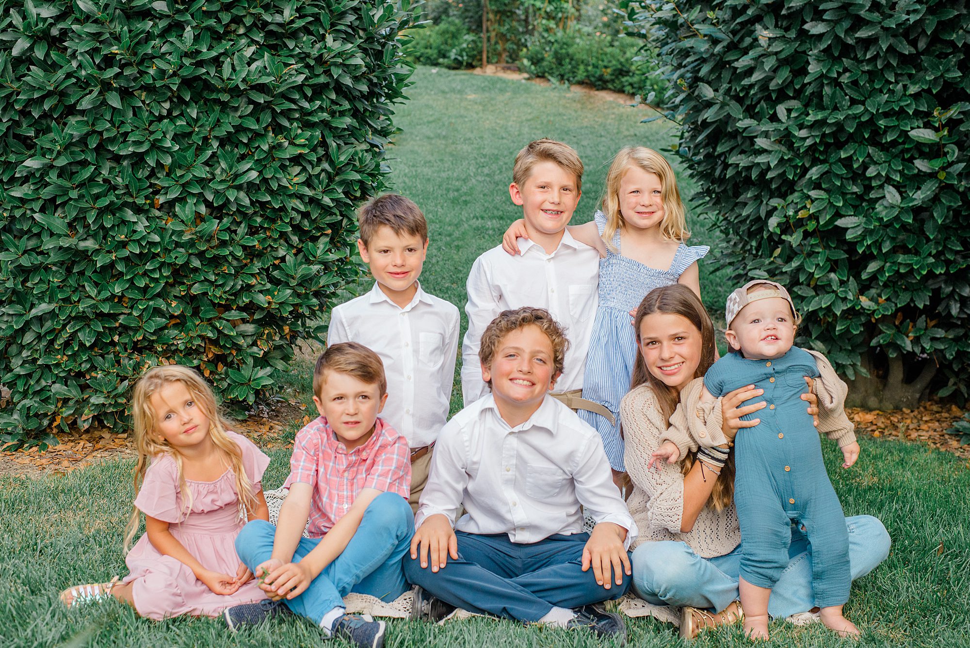 cousins sit together for portraits during Summer Garden Extended Family Session