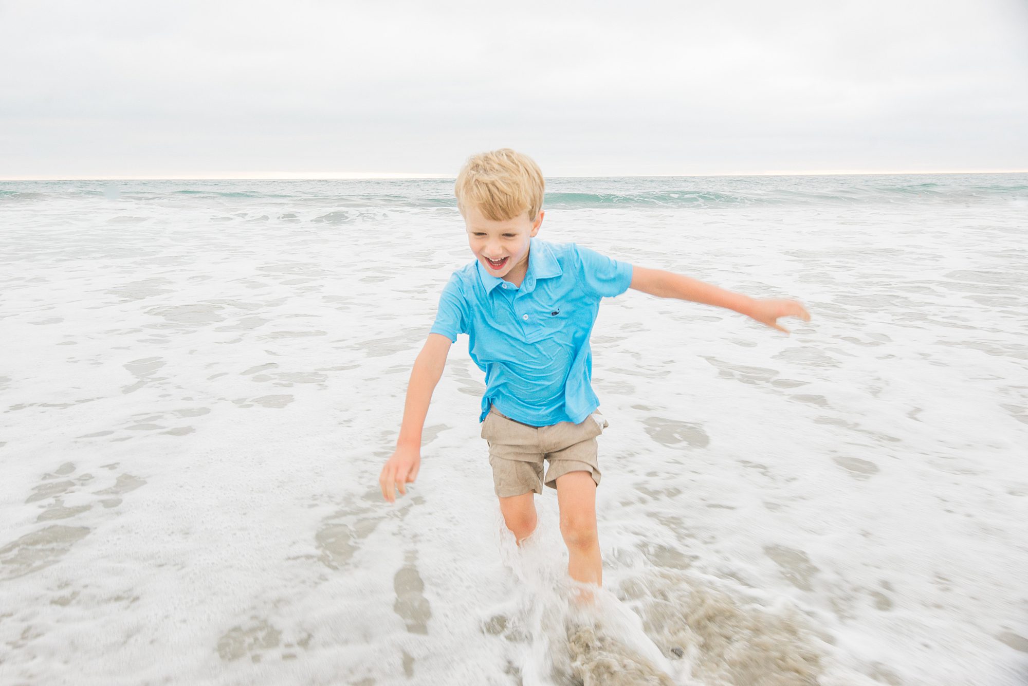 little boy playing in the water from Del Mar Beach Family Session